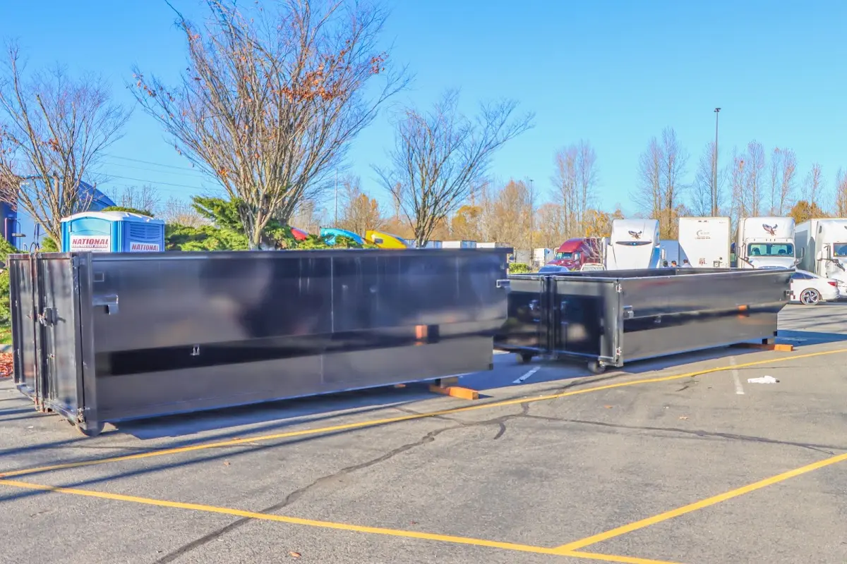 Professional dumpster rental service with roll-off container on residential driveway in Stuart